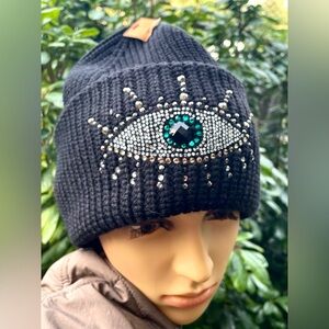 Black Beanie with Eye Design by Kurt Geiger.
NWOT